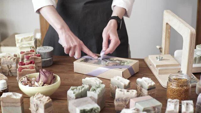 Female soap maker holds handmade soap in her hands. A lot of different sliced pieces. Eco-friendly natural craft cosmetics