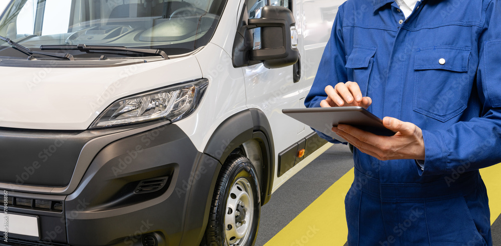 Poster manager with a digital tablet on the background of delivery van. fleet management