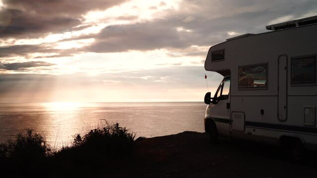 Camper rv camping on coast sea shore in the morning time. Holidays in Spain, travel with motor home.