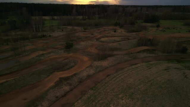 Aerial view of a dirt track at sunset in a grassland ecoregion