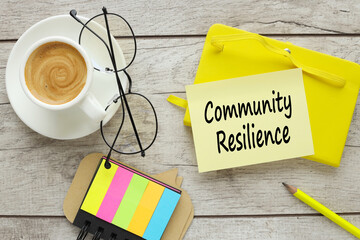 Community resilience symbol. yellow sticker with text near a cup of coffee