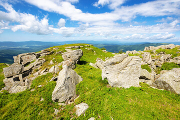 green alpine hills and meadow of carpathians. stones and boulders among the grass beneath a sky with clouds. summer vacations in ukrainian mountains - 784602116