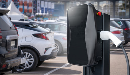 .Electric vehicles charging station on a background of a row of cars. Concept..Electric vehicles...