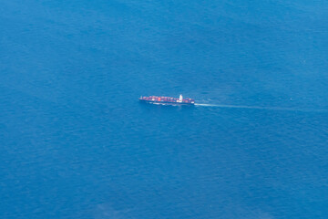 An aerial view of an offshore tanker or dry cargo ship sailing on the sea. Transportation of goods by sea.