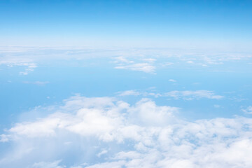 Fototapeta na wymiar An aerial view of white fluffy clouds and sky.