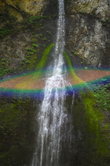 waterfall with rainbow in the forest