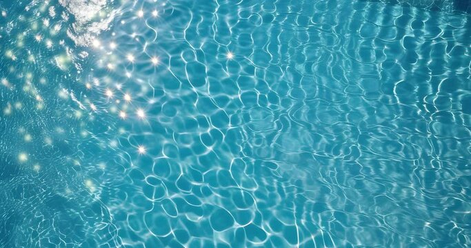 Sparkles on the waves of crystal clear water in the swimming pool. Light of the sun. Summer image. スイミングプールの透明な水の波の上で輝きます。太陽の光。夏のイメージ。