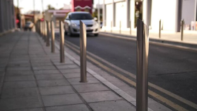 Close-up of bollards placed along the road. Metal road bollards. Road bollards made of metal.