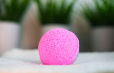 Close-up of pink ball. Scented candle bomb for the bathroom. Therapy concept. Spa at home. Taking relaxing bath.