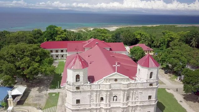 Loon, Bohol, Philippines - Aerial of the rebuilt Our Lady of Light Church, commonly known as Loon church, with the Bohol strait behind.