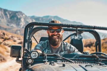 Smiling bearded man driving his off-road car in the mountains