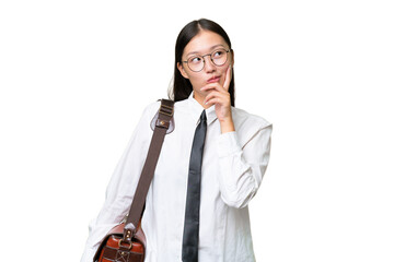 Young Asian business woman over isolated background having doubts and with confuse face expression