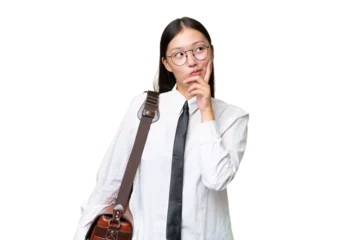 Selbstklebende Fototapeten Young Asian business woman over isolated background having doubts and with confuse face expression © luismolinero