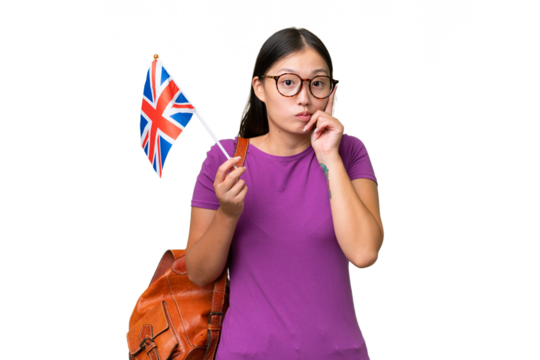 Young Asian woman holding an United Kingdom flag over isolated background thinking an idea