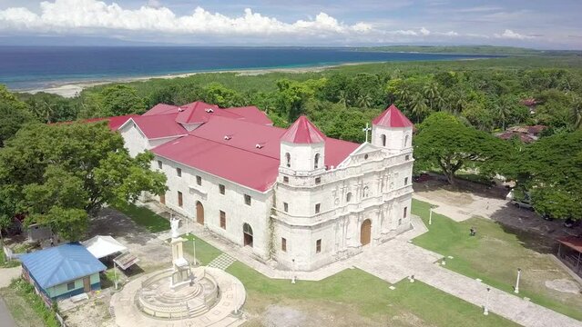 Loon, Bohol, Philippines - Aerial of the rebuilt Our Lady of Light Church, commonly known as Loon church, with the Bohol strait behind.