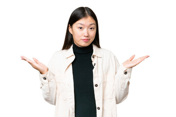 Young Asian woman over isolated chroma key background making doubts gesture - 784623708