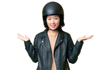 Young Asian woman with a motorcycle helmet over isolated chroma key background with shocked facial...