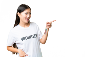 Young volunteer woman over isolated chroma key background pointing finger to the side and presenting a product