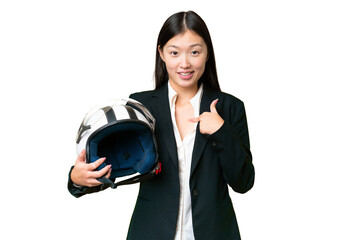 Young Asian woman with a motorcycle helmet over isolated chroma key background with surprise facial...