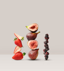 Creative layout made of strawberry, figs and blackberry on the beige background. Food concept. Macro concept.
