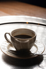 A cup of unfinished coffee on a tray.