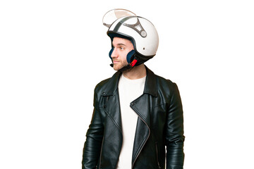 Young handsome blonde man with a motorcycle helmet over isolated chroma key background looking to...