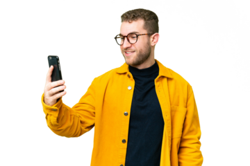 Young handsome blonde man over isolated chroma key background making a selfie