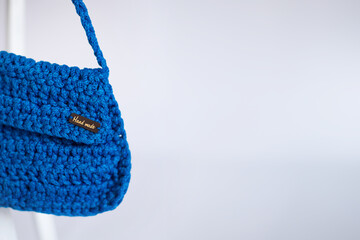 Bright Blue Crocheted Clutch with Floral Accent with unbranded text 