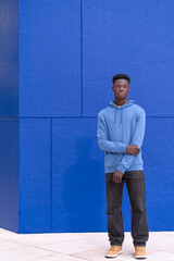Man Standing in Front of Blue Wall
