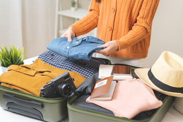 Vacation, holiday travel, traveler asian young woman, girl hand folding clothes packing and...