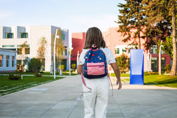 Girl with backpack walking to school