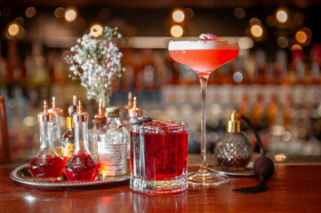 Two alcoholic cocktails on the bar counter
