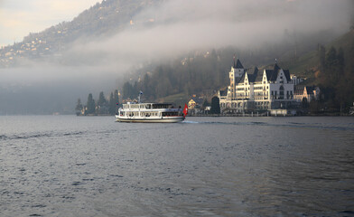 City of Vitznau on beautiful Lake Lucerne in the fog. Switzerland, Europe.