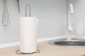 The kitchen towel holder stands on the kitchen countertop.