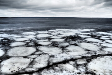 Ice drift in spring on Lake Onega, Karelia. Dangerous thin spring ice in April. Aggregate...