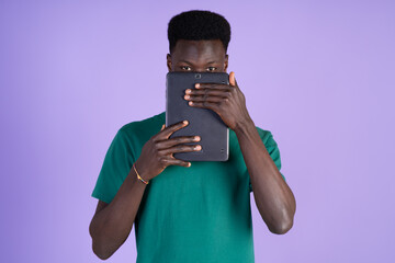 Man Covering Face With Tablet