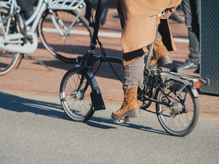 Fototapeta premium Person Riding Folding Bicycle in the City