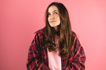 Portrait of minded brunette woman bite lips, look at side think thoughts plan wear plaid shirt,...