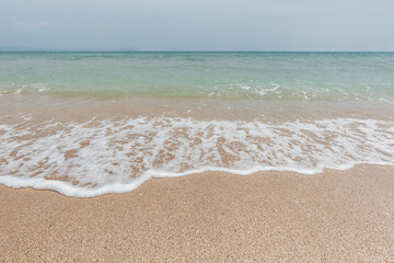 Fototapeta na wymiar Beautiful beach and tropical sea, Wave of the sea on the sand beach