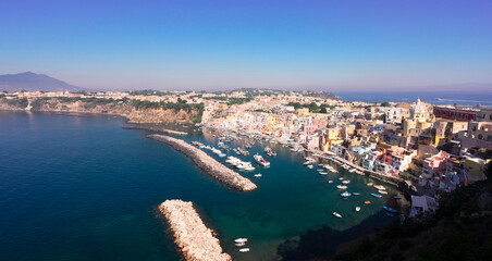 Fototapeta na wymiar Procida island colorful town with small harbour from above, Italy, web banner format