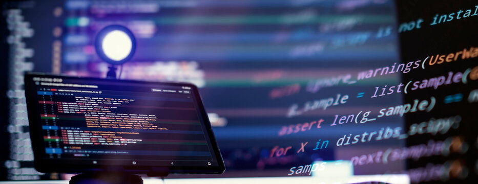 Work from home. Programmer coding code on notebook screen at home.