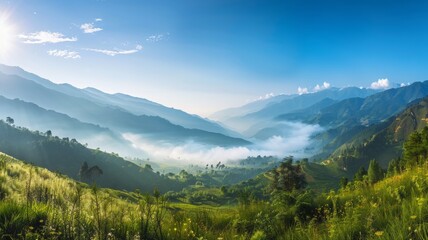 Serene mountain landscape with misty valleys - A tranquil scenery of misty valleys amidst mountain ranges under a clear blue sky conveys a sense of peace and grandeur