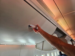 Man Holding Remote Control on Airplane