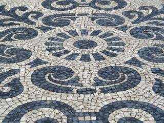 Fototapeta na wymiar artistic Portuguese paving with ornamental patterns