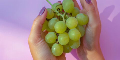 Fresh Green Grapes Held in Woman's Hands with Manicured Nails
