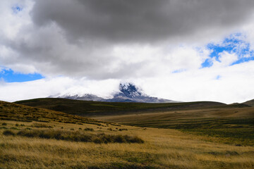 Antisana volcano with ice and snow on sunny day with blue sky and white clouds. Landscape in Ecuador 