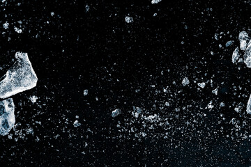 A shards of crushed ice on a black background.