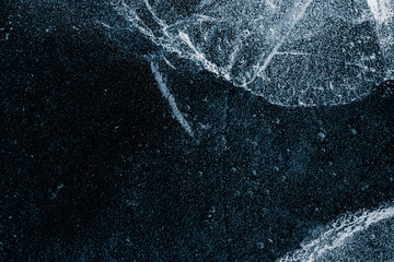 Cracked ice texture background. The textured cold frosty surface of the ice on a black background. - 784692733