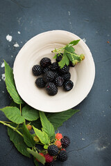 Wild black forest raspberries in a clay bowl