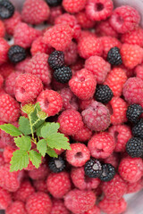Background of raspberry and wild blackberry berries